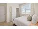 Light-filled bedroom featuring a bright window, a walk-in closet, and neutral-toned decor at 8591 Seabiscuit Rd, Lithonia, GA 30058