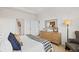 Bright bedroom featuring a decorative dresser, comfortable chair, and a patterned blanket at 8591 Seabiscuit Rd, Lithonia, GA 30058