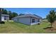 This single-Gathering home features a well-maintained lawn and beautiful landscaping at 8591 Seabiscuit Rd, Lithonia, GA 30058