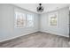 Bright bedroom featuring light gray walls, hardwood floors, ceiling fan, and two windows with natural light at 1180 Fleming St, Atlanta, GA 30080
