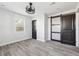 Bedroom showcasing hardwood floors, a ceiling fan, natural light, and a modern barn door at 1180 Fleming St, Atlanta, GA 30080