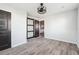 Bedroom showcasing hardwood floors, a ceiling fan, natural light, and modern barn door that leads to the kitchen at 1180 Fleming St, Atlanta, GA 30080