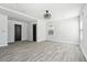 Bright bedroom featuring light gray walls, hardwood floors, ceiling fan, and windows with natural light at 1180 Fleming St, Atlanta, GA 30080