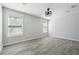 Bright bedroom featuring light gray walls, hardwood floors, ceiling fan, and windows with natural light at 1180 Fleming St, Atlanta, GA 30080