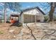 A home featuring a covered porch with an unfinished garage and a well-manicured lawn at 1180 Fleming St, Atlanta, GA 30080