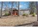 View of home showcasing the covered porch, backyard with mature trees, and white and black color scheme at 1180 Fleming St, Atlanta, GA 30080