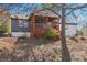 Charming home featuring a covered porch with red accents and a well-maintained yard surrounded by mature trees at 1180 Fleming St, Atlanta, GA 30080
