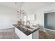 Close up of the kitchen island with white cabinets, stainless steel faucet, and marble countertops at 1180 Fleming St, Atlanta, GA 30080