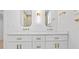 Elegant bathroom with double sinks, white cabinetry, gold fixtures, and modern mirrors at 1557 Alder Se Ct, Atlanta, GA 30317