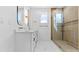 Modern bathroom features a double vanity, marble floors, an enclosed glass shower with gold hardware at 1557 Alder Se Ct, Atlanta, GA 30317