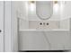 Modern bathroom featuring white marble countertops, double vanity, stylish mirror, and glass shower door at 1557 Alder Se Ct, Atlanta, GA 30317
