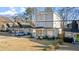 View of gray colored three-story home with a well maintained lawn and lush greenery at 1557 Alder Se Ct, Atlanta, GA 30317