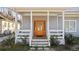 Inviting covered front porch, featuring a stylish wood door and stone accents at 1557 Alder Se Ct, Atlanta, GA 30317