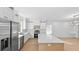 Bright kitchen featuring white cabinetry, stainless steel appliances, a spacious island and hardwood floors at 1557 Alder Se Ct, Atlanta, GA 30317