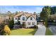 Charming two-story home with neutral exterior, manicured lawn, mature landscaping and a pergola-covered patio at 225 Arbor Creek Way, Roswell, GA 30076