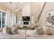 Cozy living room with a fireplace, vaulted ceiling, and large windows with lots of natural light at 225 Arbor Creek Way, Roswell, GA 30076