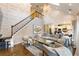 Bright living room features modern decor, a vaulted ceiling, a staircase, and hardwood floors at 225 Arbor Creek Way, Roswell, GA 30076