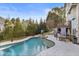 Inviting pool with a spa, lush landscaping, and an outdoor dining area for relaxing and entertaining at 225 Arbor Creek Way, Roswell, GA 30076