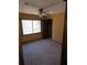 Bedroom with large window, closet, and carpeted flooring at 3412 Sherrod Sw Dr, Marietta, GA 30060