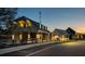 Community buildings at dusk featuring covered patios, varied architectural styles, and ample parking at 54 Black Gum Ln # 48, Auburn, GA 30011