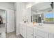 The primary bathroom offers dual sinks with white cabinets, a large mirror, and a separate shower at 18 Village Trce, Rydal, GA 30171