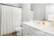 Bright bathroom featuring a white vanity, framed mirror and a shower-tub combination with a white shower curtain at 18 Village Trce, Rydal, GA 30171