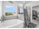 This bathroom features a soaking tub and a glass-enclosed shower with tile surround at 18 Village Trce, Rydal, GA 30171