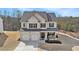 Inviting two-story home with a two-car garage, front porch, and beautiful landscaping at 18 Village Trce, Rydal, GA 30171