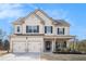 Charming two-story home with a two-car garage, covered porch, and manicured lawn at 18 Village Trce, Rydal, GA 30171