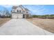 Home exterior featuring a large front lawn and a two-car garage at 18 Village Trce, Rydal, GA 30171