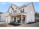 Charming two-story home features a welcoming front porch and attached two-car garage at 18 Village Trce, Rydal, GA 30171