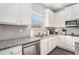 Kitchen with white cabinets, granite countertops, and stainless steel appliances at 18 Village Trce, Rydal, GA 30171
