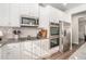 Kitchen area featuring granite countertops, subway tiles, and stainless steel appliances at 18 Village Trce, Rydal, GA 30171
