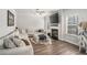 Comfortable living room featuring wood flooring, fireplace, and a large sofa at 18 Village Trce, Rydal, GA 30171