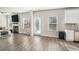 Open-concept living room featuring a fireplace and wood flooring at 18 Village Trce, Rydal, GA 30171
