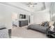 Bright main bedroom with a tray ceiling, dresser, and entry to the bathroom at 18 Village Trce, Rydal, GA 30171