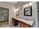 Bright bathroom features double vanity with granite countertops and framed mirrors at 2506 Creek Station Dr, Buford, GA 30519