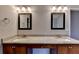 Double vanity with granite countertops and framed mirrors at 2506 Creek Station Dr, Buford, GA 30519