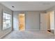 Bright bedroom with neutral walls and carpeting plus access to bathroom at 2506 Creek Station Dr, Buford, GA 30519