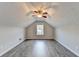 Attic bedroom featuring light walls, luxury vinyl flooring, and a ceiling fan at 2506 Creek Station Dr, Buford, GA 30519