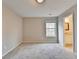 Carpeted bedroom featuring neutral walls, natural light, and bathroom access at 2506 Creek Station Dr, Buford, GA 30519