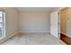 Bright bedroom featuring neutral walls, plush carpeting, and a doorway to another room at 2506 Creek Station Dr, Buford, GA 30519