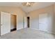 This bright bedroom has neutral carpeting and a ceiling fan at 2506 Creek Station Dr, Buford, GA 30519