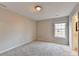 Bedroom featuring neutral paint, plush carpeting, natural light, and bathroom access at 2506 Creek Station Dr, Buford, GA 30519