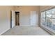 This bright bedroom has neutral carpeting and access to another room at 2506 Creek Station Dr, Buford, GA 30519