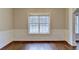 Dining room showcasing hardwood floors, large window, and decorative trim at 2506 Creek Station Dr, Buford, GA 30519