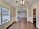 Bright dining room with wood floors, natural light, and archway leading to another room at 2506 Creek Station Dr, Buford, GA 30519