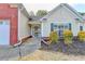 Inviting front entrance showcasing a well-manicured garden, and a modern door, enhanced by exterior lighting at 2506 Creek Station Dr, Buford, GA 30519