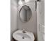 A well-lit half bathroom with a modern sink, decorative mirror, and sleek fixtures, offering style and functionality at 2506 Creek Station Dr, Buford, GA 30519