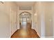 Bright hallway with hardwood floors and an arched doorway, creating a seamless flow into the living spaces at 2506 Creek Station Dr, Buford, GA 30519